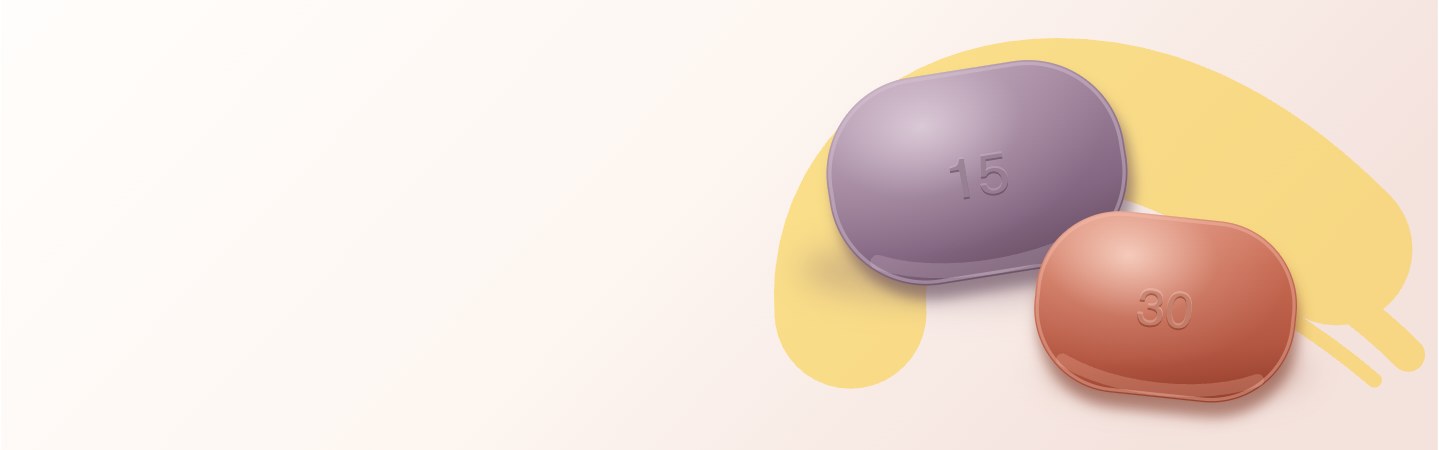 Deux comprimés oblongs, l'un mauve dosé à 15 mg, l'autre terracotta dosé à 30 mg